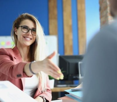 Premium Photo _ A beautiful woman in a suit happily greets a man